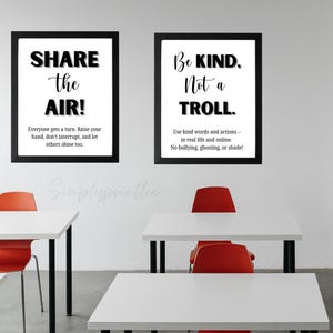May include: Two framed posters with black frames and white backgrounds. One poster reads "SHARE the AIR!" and the other says "Be KIND. Not a TROLL." The posters are in a classroom setting with white desks and red chairs.