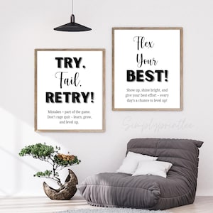 May include: Two framed motivational posters with white backgrounds and black text. One reads "TRY. Fail. RETRY!" with an inspirational quote. The other says "Flex Your BEST!" with a motivational message. A gray beanbag chair and a bonsai tree are in the foreground.