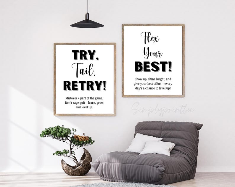 May include: Two framed motivational posters with white backgrounds and black text. One reads "TRY. Fail. RETRY!" with an inspirational quote. The other says "Flex Your BEST!" with a motivational message. A gray beanbag chair and a bonsai tree are in the foreground.