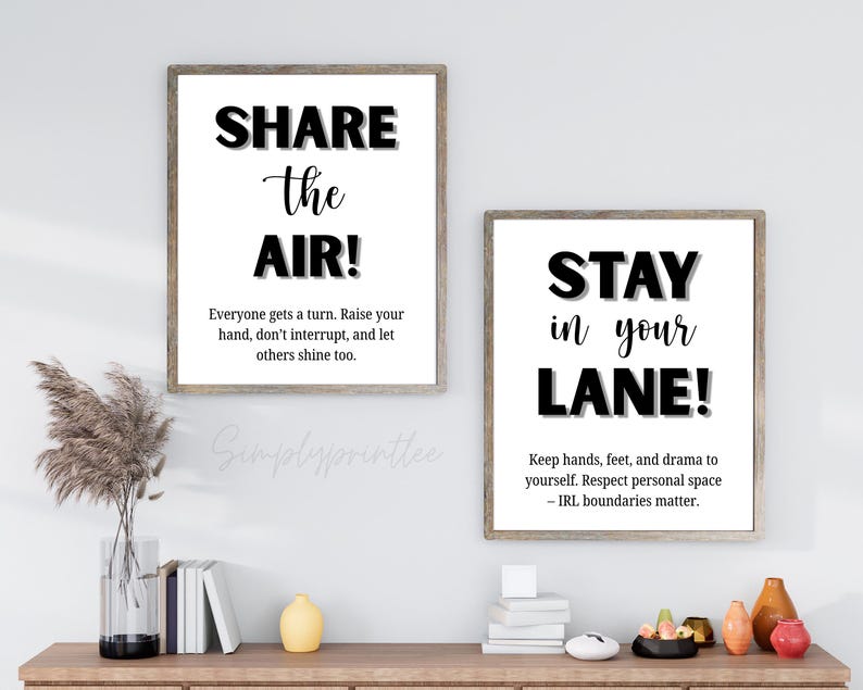 May include: Two framed wall art prints with inspirational quotes. The first reads "SHARE the AIR!" and the second says "STAY in your LANE!". Both prints have a white background with black text and are in wooden frames.