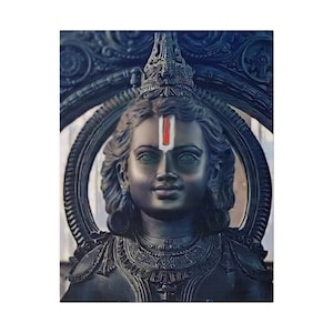 May include: A black statue of a Hindu deity with a red and white vertical line on their forehead. The statue is adorned with intricate details and is set against a dark blue background.