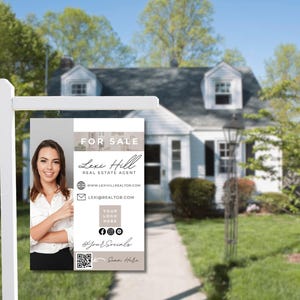 May include: A real estate sign with a photo of a woman and the text "FOR SALE", "Lexi Hill", "REAL ESTATE AGENT", "www.LEXIHILLREALTOR.COM", "LEXI@REALTOR.COM", "YOUR LOGO HERE", and "Sean Hele".