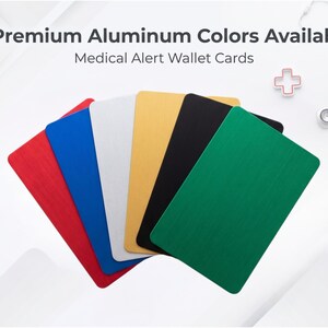 May include: A selection of six aluminium medical alert wallet cards in red, blue, white, gold, black, and green. The cards are rectangular with rounded corners. Text on the image reads "6 Premium Aluminium Colours Available" and "Medical Alert Wallet Cards."