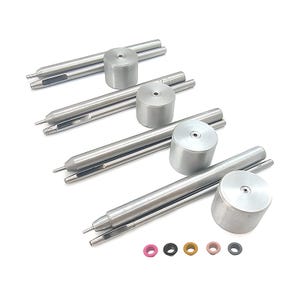 May include: Four sets of silver-colored metal tools, each consisting of a long cylindrical rod with a pointed tip, a hollow tube, and a cylindrical cap with a small center hole. Five small, colorful circular rings in pink, black, gold, tan, and gray.