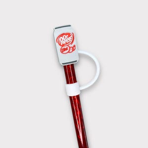 May include: A red and white striped reusable straw with a white Dr Pepper Diet can-shaped topper. The straw has a white ring around it.