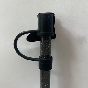 May include: Black silicone straw with a black glitter design and a black silicone loop handle.