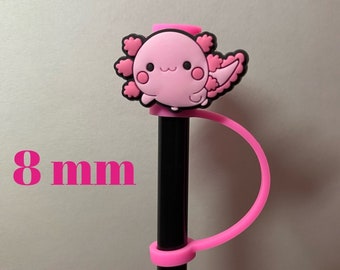 May include: Pink axolotl pen holder with a black pen. The holder has a pink loop that goes around the pen. The axolotl is 8 mm wide.