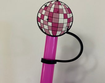 May include: Pink and white disco ball straw topper with a black plastic ring. The topper is designed to fit on a straw.