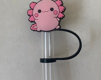 May include: A pink axolotl character straw topper with a black straw and a black clip.