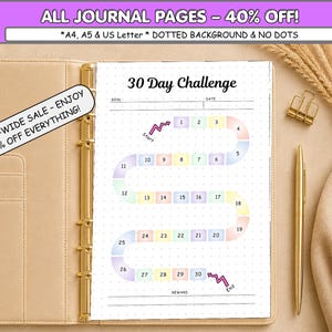 May include: A 30-day challenge tracker page inside a gold-ringed binder. The page features a winding path of numbered pastel-coloured boxes from 1 to 30, with a start and end arrow, goal and date lines, and a reward section on a dotted background.