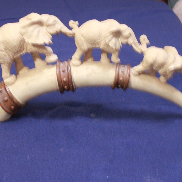 ivory tone molded tusk and elephants