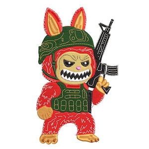 May include: Embroidered design of a red creature with bunny ears, wearing a green helmet and vest, holding a black rifle. The creature has an angry expression with sharp teeth. The design is detailed with various textures.
