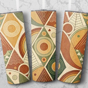 May include: Three insulated tumblers with a geometric design in shades of brown, orange, green, and cream. The pattern includes circles, triangles, and curved lines. The tumblers have a silver rim and lid.