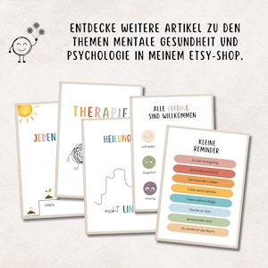 May include: A collection of art prints with mental health themes. The prints feature colorful text and illustrations, including the words "Therapie," "Heilung," and "Kleine Reminder." The prints are displayed on a light background.