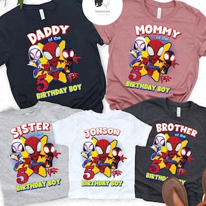 May include: Five matching t-shirts featuring a cartoon Spider-Man with other characters. The shirts are in different colors and say "Daddy of the Birthday Boy", "Mommy of the Birthday Boy", "Sister of the Birthday Boy", "Jonson of the Birthday Boy", and "Brother of the Birthday Boy".