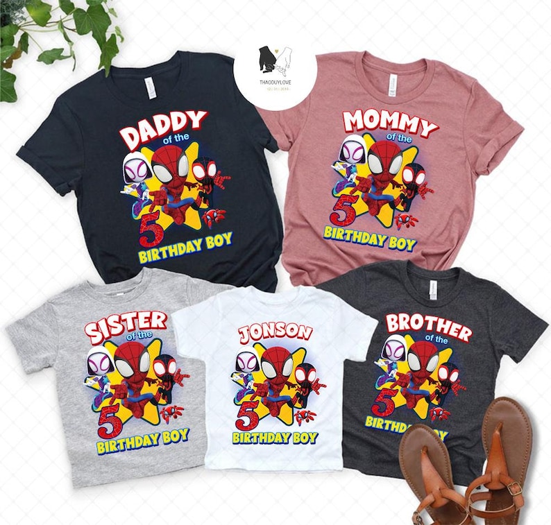May include: Five matching t-shirts featuring a cartoon Spider-Man with other characters. The shirts are in different colors and say "Daddy of the Birthday Boy", "Mommy of the Birthday Boy", "Sister of the Birthday Boy", "Jonson of the Birthday Boy", and "Brother of the Birthday Boy".