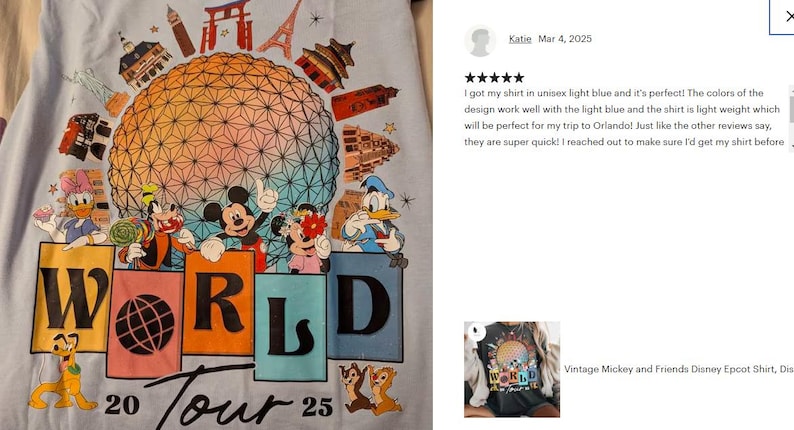 May include: Light blue t-shirt with a colorful graphic of Mickey Mouse and friends at Epcot's World Showcase. The graphic includes the Epcot ball, the World Showcase Lagoon, and the text "WORLD 20 Tour 25".