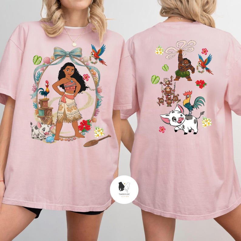 以下が含まれることがあります： 明るいピンク色のTシャツ。前面には、漫画のキャラクター、オウム、豚、鶏が装飾的なフレームの中に描かれたカラフルなグラフィックデザイン。背面にも同様のデザインが施されています。