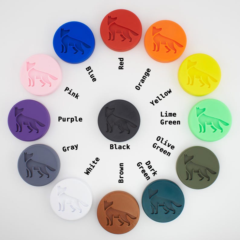 May include: A colour chart with 12 different coloured circles, each with a wolf silhouette. The circles are arranged in a circle, with the colours being pink, purple, grey, white, blue, black, brown, red, orange, yellow, lime green, olive green, and dark green.