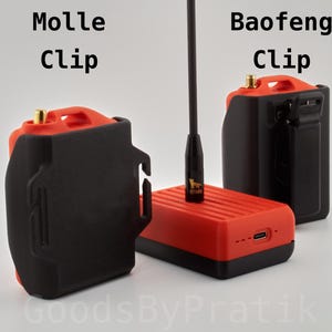 May include: Two black radio clips, one labeled "Molle Clip" and the other "Baofeng Clip". The Baofeng clip is attached to a red radio with a black antenna.