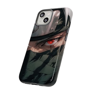 May include: A black phone case with a graphic of a masked anime character with a red eye. The character has white hair and is wearing a green mask.