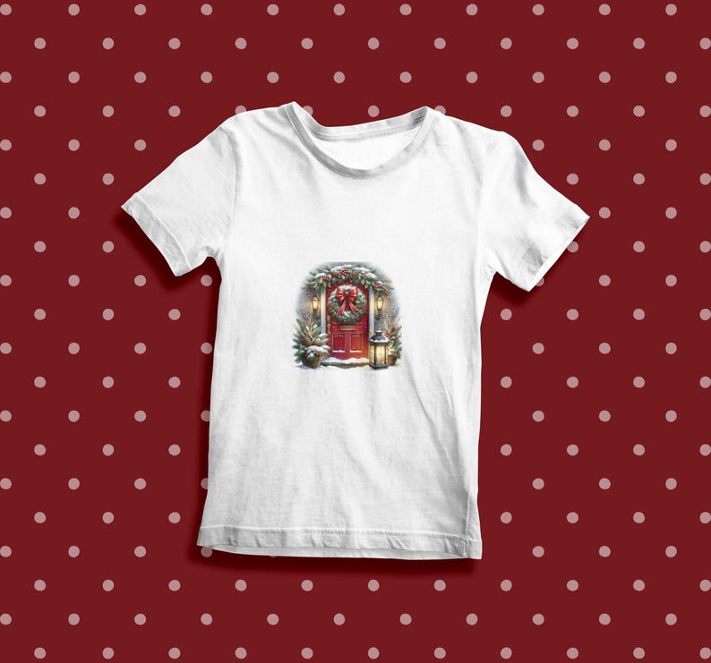 May include: White t-shirt with a Christmas-themed image of a red door with a wreath, lights, and snow.