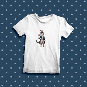 May include: White t-shirt with a cartoon illustration of a cat wearing a red, white, and blue Uncle Sam hat and holding a small American flag.