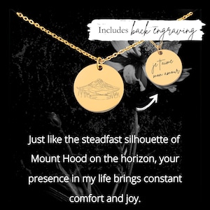 May include: Gold-colored necklace with two round pendants. One pendant features a mountain landscape engraving, the other says "Je t'aime mon amour". The text "Includes back engraving" is also visible.