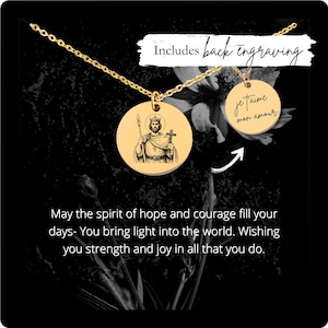 May include: Gold-colored pendant necklace with two round charms. One charm features an engraved image of a saint holding a staff and cross. The other charm has the phrase "je t'aime mon amour" engraved. The text "Includes back engraving" is also present.