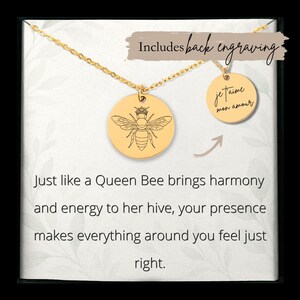 May include: Gold-colored necklace with two round pendants. One pendant features a bee design with a crown, and the other says "je t'aime mon amour". The text on the card reads "Just like a Queen Bee brings harmony and energy to her hive, your presence makes everything around you feel just right."