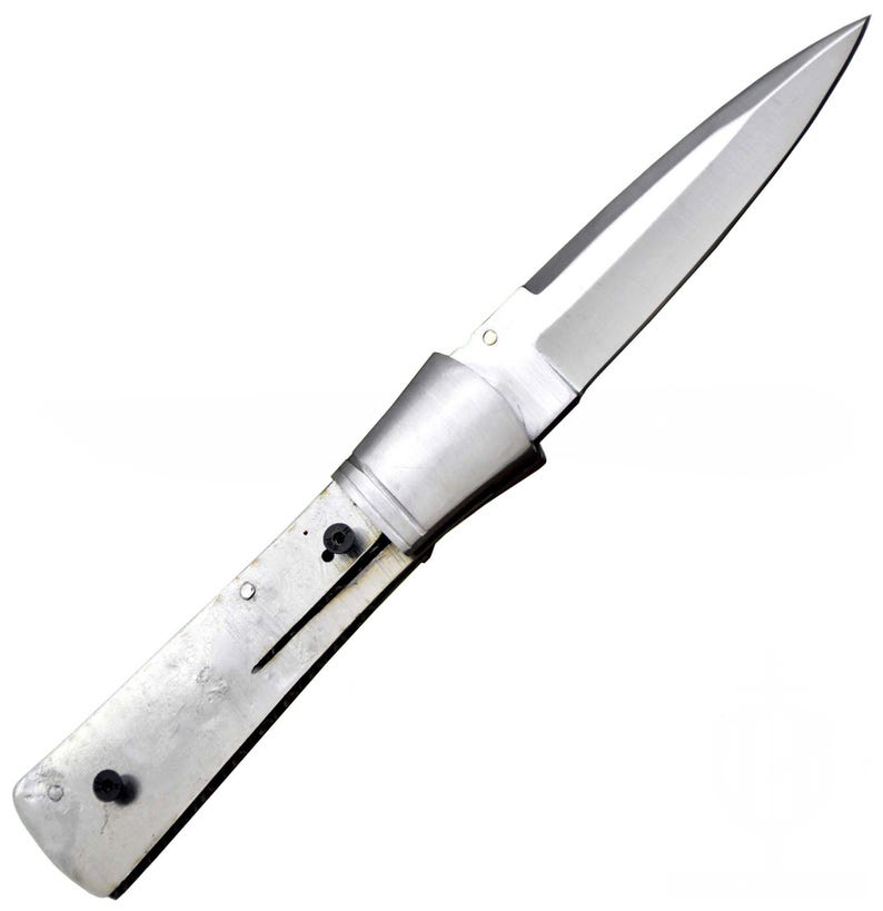 May include: A stainless steel folding knife with a pointed blade. The handle is made of a brushed metal material. The knife is open, displaying the full length of the blade and handle. The blade is sharp and reflective.