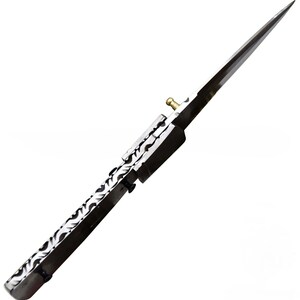 May include: A long, sharp, silver and black spearhead with a decorative pattern on the handle. The spearhead has a pointed tip and a brass-colored fitting. The design is symmetrical and appears to be a historical or fantasy weapon.