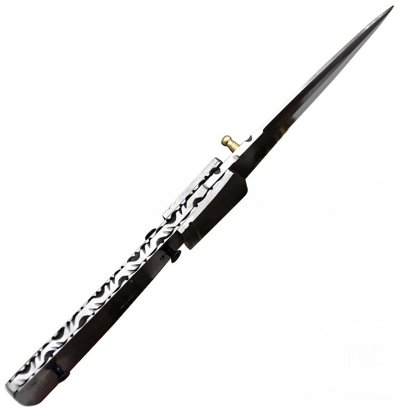 May include: A long, sharp, silver and black spearhead with a decorative pattern on the handle. The spearhead has a pointed tip and a brass-colored fitting. The design is symmetrical and appears to be a historical or fantasy weapon.