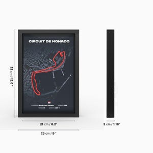 May include: A black framed poster with a map of the Circuit de Monaco race track. The track is highlighted in red. The poster is 12.6 inches tall and 8.2 inches wide. The frame is 1.18 inches wide.