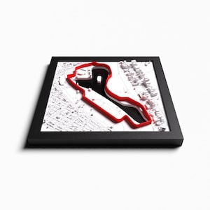 Peut inclure: Modèle 3D blanc d'une ville avec une piste de course rouge, encadré en noir.