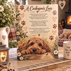 May include: A rectangular wooden sign featuring a poem titled A Cockapoo's Love, decorated with brown paw prints, heart outlines, and white daisy flowers. The center displays a realistic illustration of a brown curly-haired dog resting its chin.
