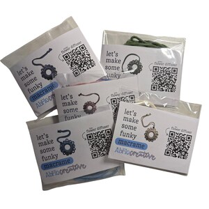 May include: Several macrame kits are displayed, each packaged in a clear plastic bag. The kits feature a flower diffuser design and include the text "let's make some funky macrame." Each kit has a QR code and the AbFlo creative logo.