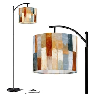 May include: A floor lamp with a black metal stand and a curved arm holding a cylindrical drum shade. The shade features a vertical striped pattern in shades of burnt orange, cream, beige, and slate blue with a visible textured paint finish.