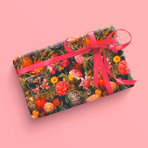 May include: A gift box wrapped in floral patterned paper with a bright pink satin ribbon tied in a bow.