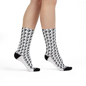 May include: White crew socks with a black hand gesture pattern. The socks have black heels and toes. The pattern is repeated across the entire sock.