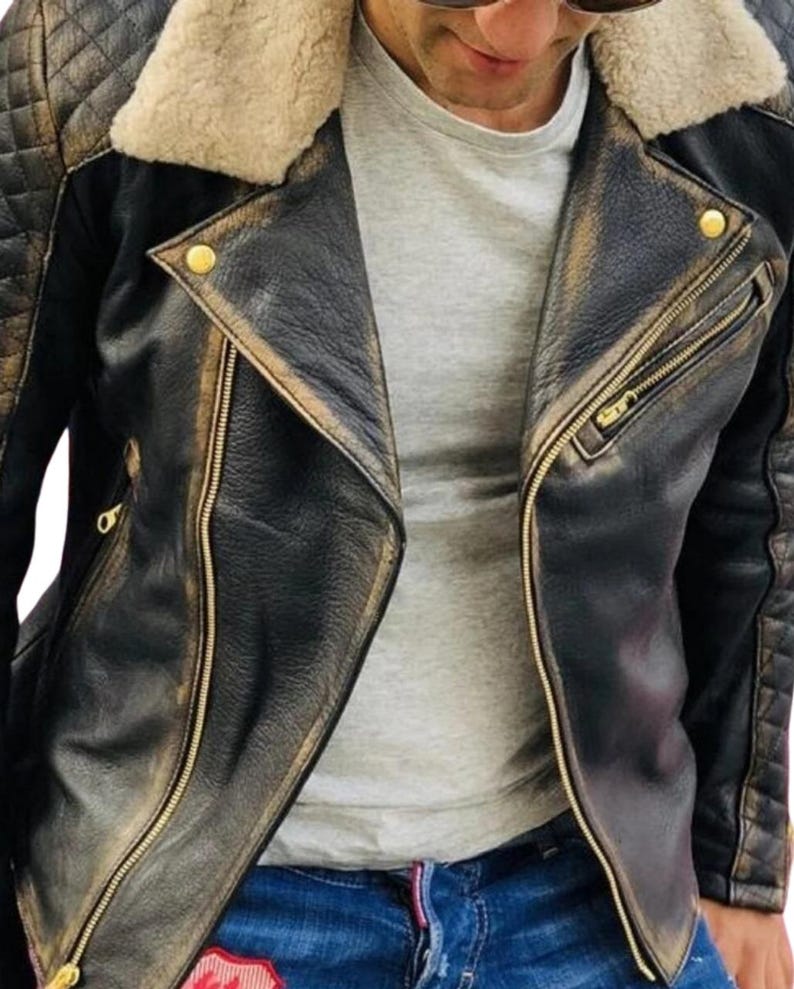 May include: A black leather jacket with a brown faux fur collar and gold zipper accents. The jacket has a distressed look and is made of a soft, supple leather.