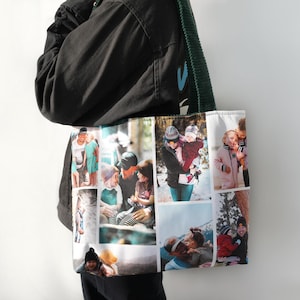 May include: A white tote bag displaying a collage of family photographs. The bag has a green strap and is carried by a person in a black jacket. The photos show various family moments, including people of different ages.