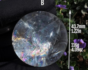 May include: A clear, spherical crystal ball labelled with the letter B, featuring internal fractures that create rainbow light refractions. The sphere measures 43.7mm in diameter and has a total weight of 116g, as indicated by the text in the image.
