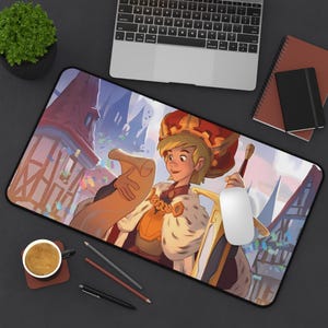 May include: A colorful illustrated mousepad featuring a cartoon king holding a scroll and a sword. The king is wearing a gold crown and a red and gold robe. The background is a cityscape with buildings and flags.