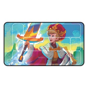 May include: A game mat with a grid of 20 squares, featuring a cartoon illustration of a young king holding a sword. The king is wearing a red and gold crown and a red and gold robe. The mat has a blue and green background with white stars. The words "Draw Well" and "Discard" are printed on the mat.