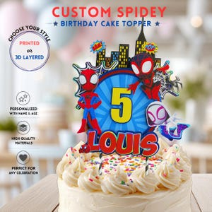 May include: A custom birthday cake topper featuring a blue circular emblem with a large yellow number 5 and the name LOUIS in red letters. The design includes three superhero characters, a city skyline, and comic-style text bubbles reading BAM and POP.