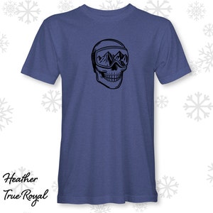 May include: A heather true royal blue t-shirt featuring a black graphic of a skull wearing a ski mask with mountain peaks inside the mask.