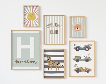 May include: A set of 7 framed prints with a variety of designs, including a sun, a cheetah, a lion, a car, and the letter H with the name Harrison. The prints are all in a light wood frame and have a white background.