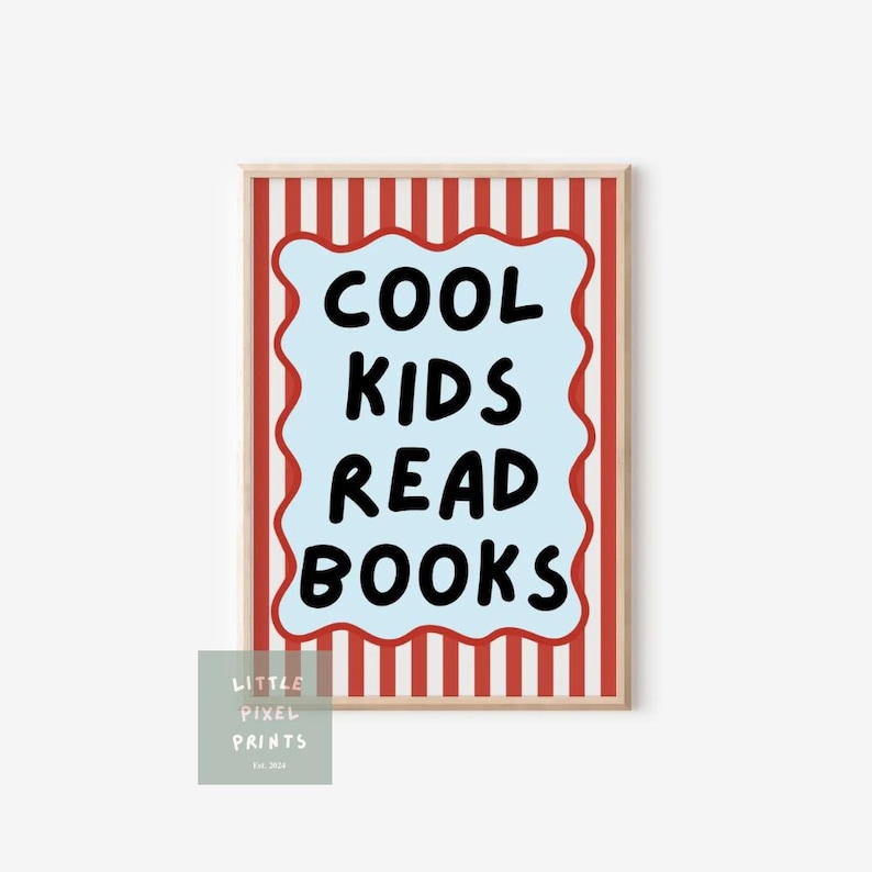 May include: A framed print with the text "COOL KIDS READ BOOKS" in black on a light blue, wavy-edged shape. The background has red and white vertical stripes, and the frame is a light wood color. A small logo is in the lower left corner.