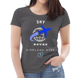 May include: A charcoal grey t-shirt with a white graphic of a blue airplane flying around a globe. The text "SKY BOUND" is below the graphic and the text "AIRPLANE MODE" is below that.